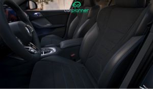 Interni BMW Serie 1 2025 con display curvo iDrive 9 e illuminazione ambientale